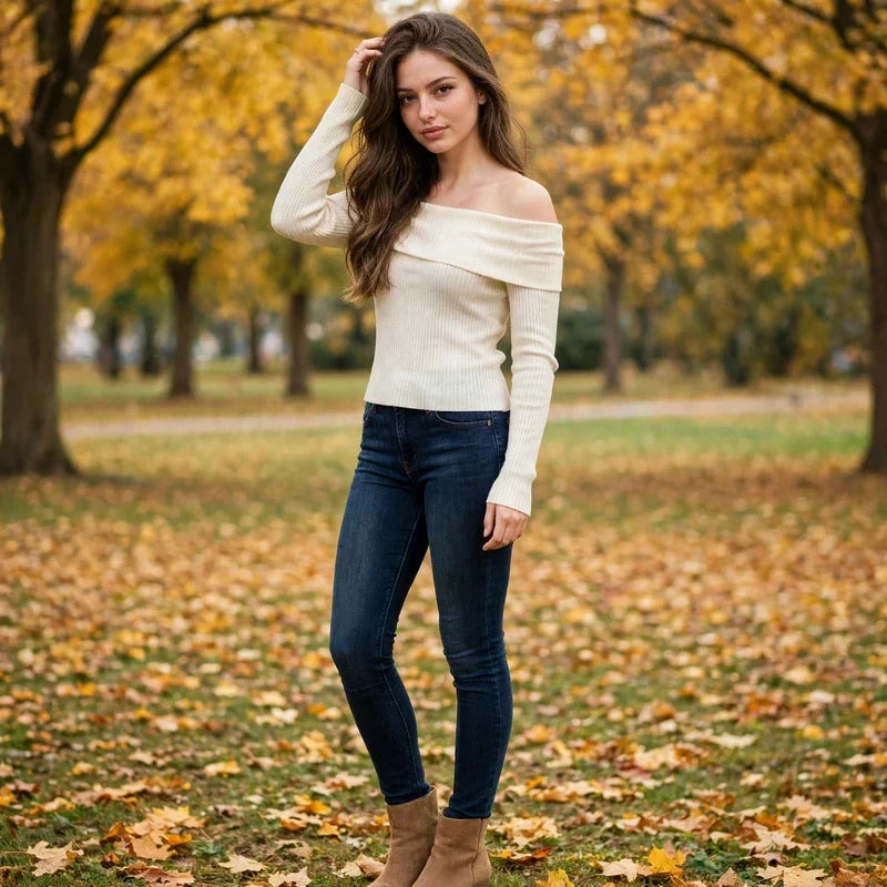 Cream off-shoulder knit sweater styled for fall in an autumn park