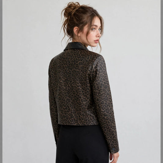 Back view of a dark brown leopard-print cropped faux leather jacket paired with black pants, gray studio background.