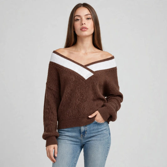 Model in brown off-shoulder V-neck sweater with white contrast trim, dropped shoulders, blue jeans, front studio view.