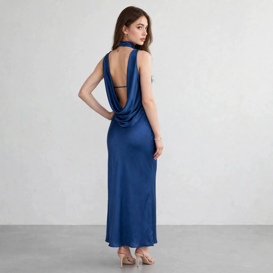 Back view of a blue satin tube maxi dress with draped open back and choker-style neckline detail, white studio background.