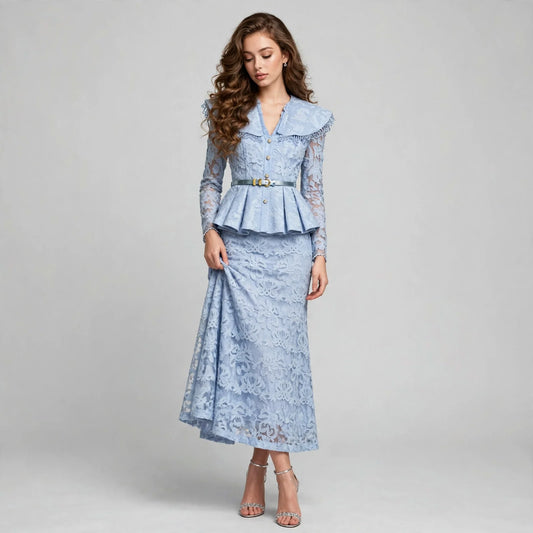 Front view of a woman in a light blue lace two-piece set with a ruffled peplum top and matching midi skirt, nude heels.