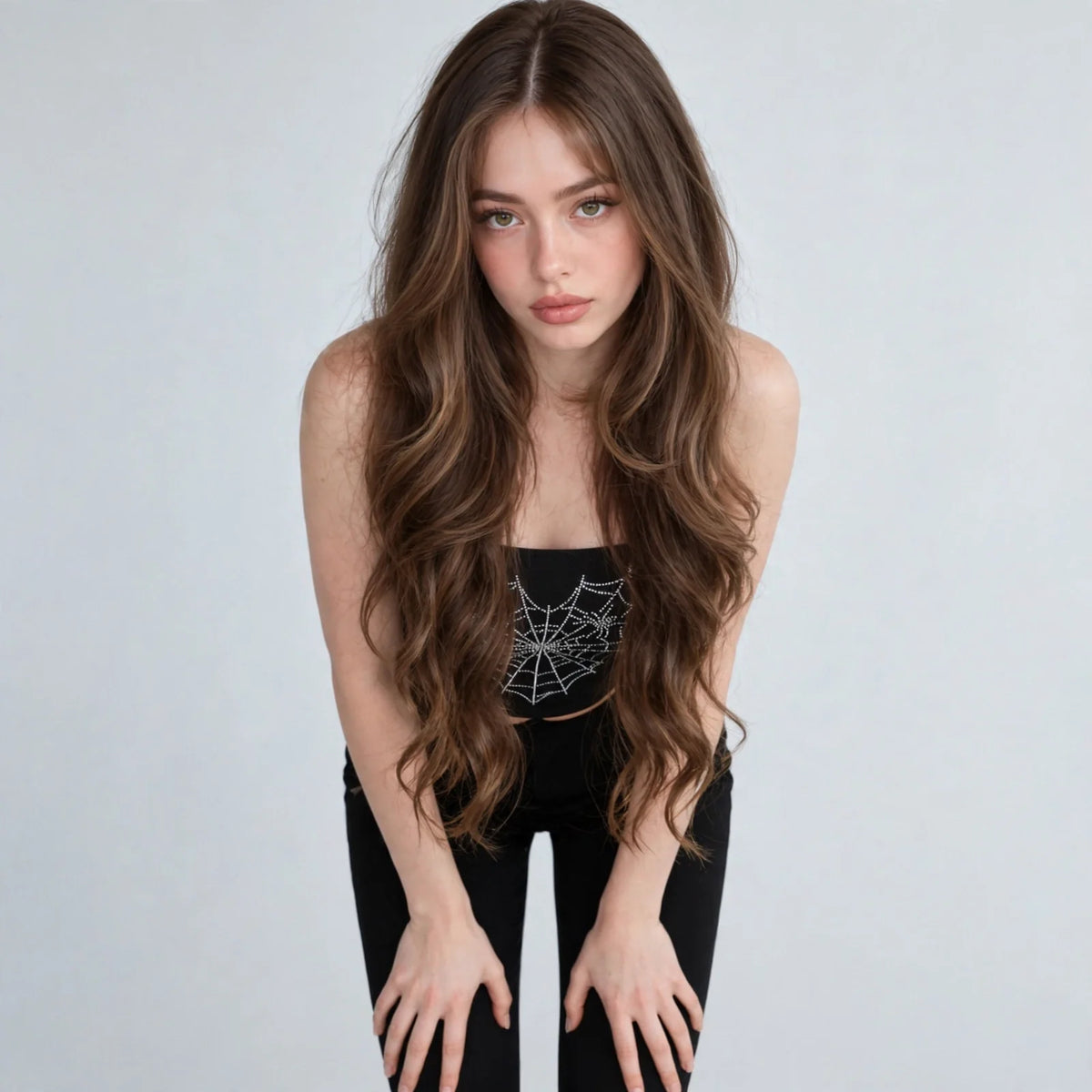 Black spider-web graphic tube top on model, alternate angle