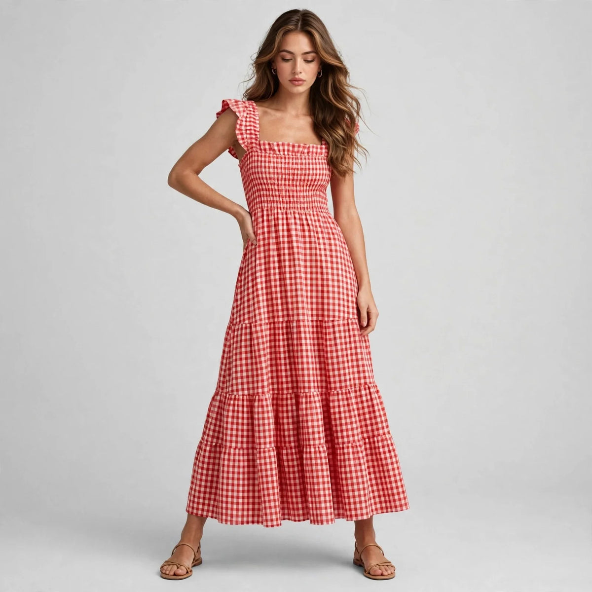 Standing model in red gingham plaid maxi dress with ruffle cap sleeves, smocked bodice and tiered skirt, full front view.