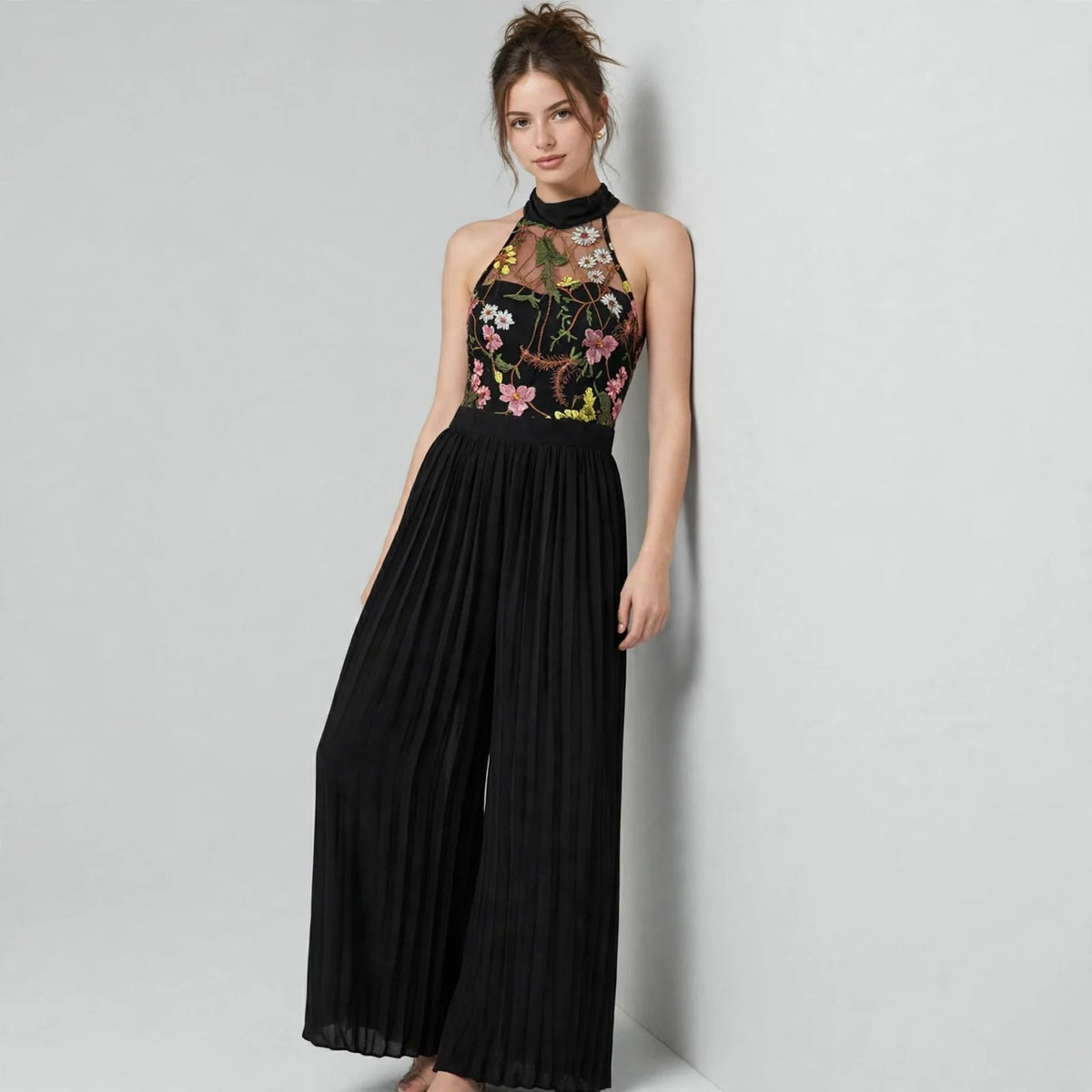 Floral halter jumpsuit on model, three-quarter view