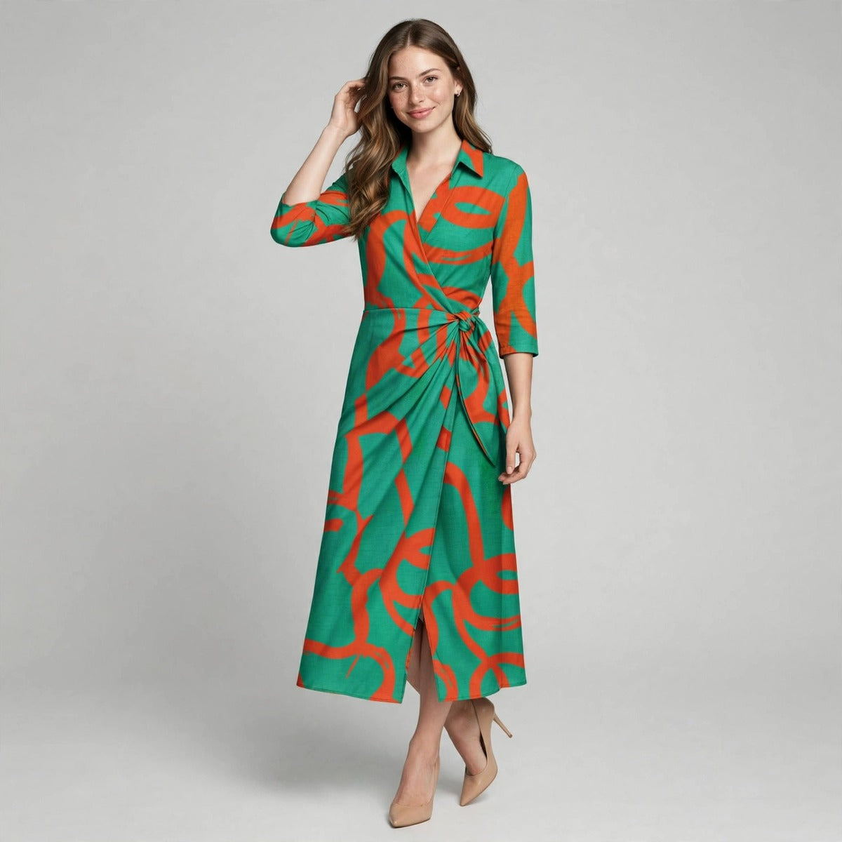 Full-length view of a woman with hand in hair wearing a green collared shirt dress with orange abstract print.