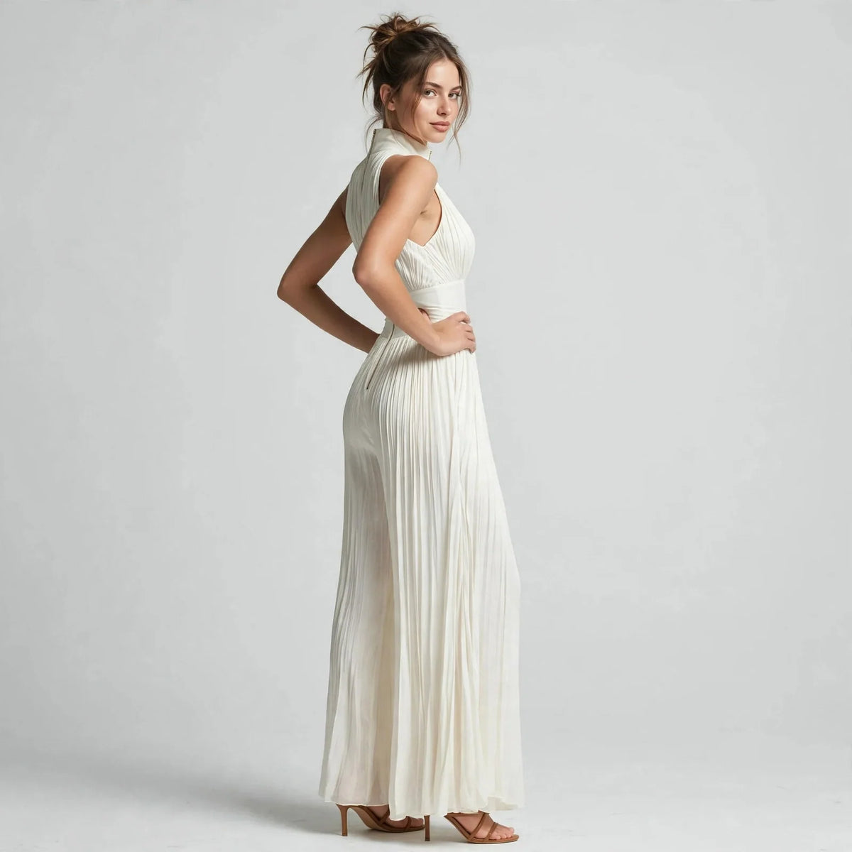 Cream pleated front-zip jumpsuit on model, three-quarter view