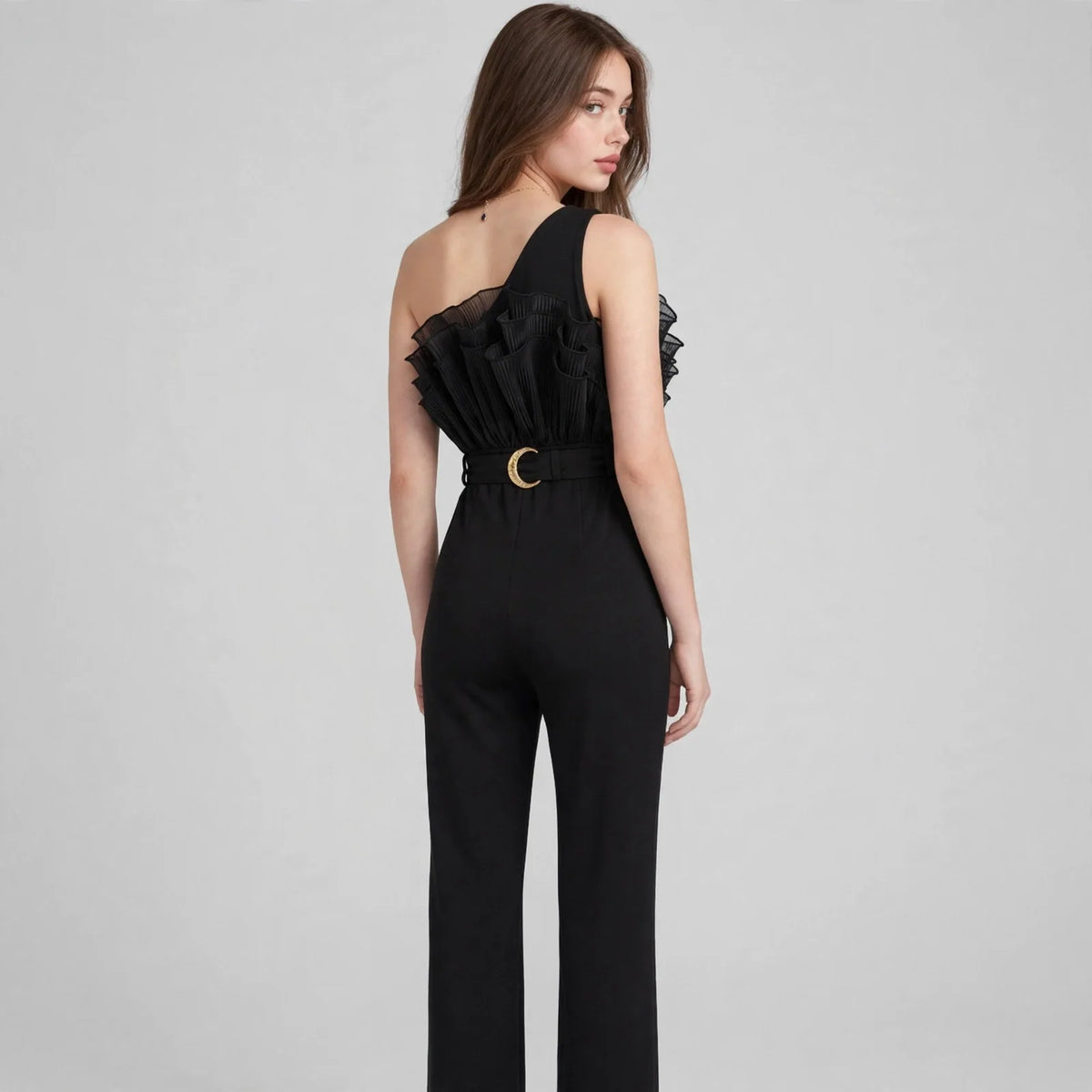 One-shoulder ruffle jumpsuit on model, styled studio pose
