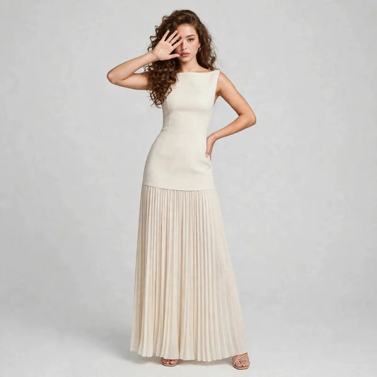 Full-length front view of a cream sleeveless maxi dress with fitted bodice and flowing pleated skirt in a gray studio.