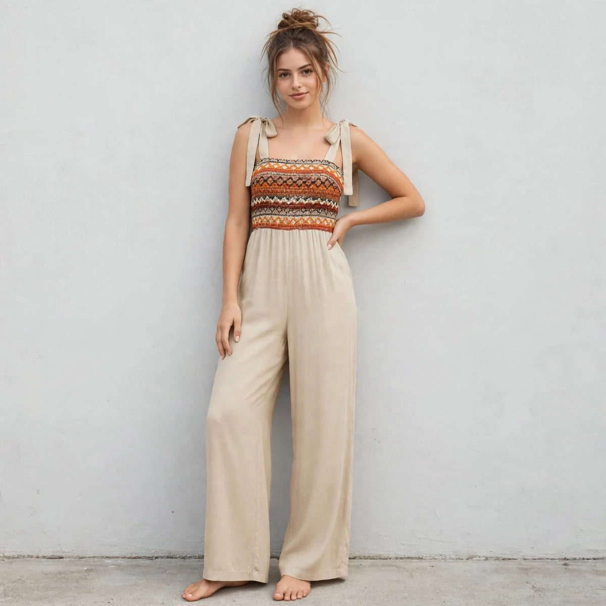 Tie-shoulder wide-leg jumpsuit on model, three-quarter view
