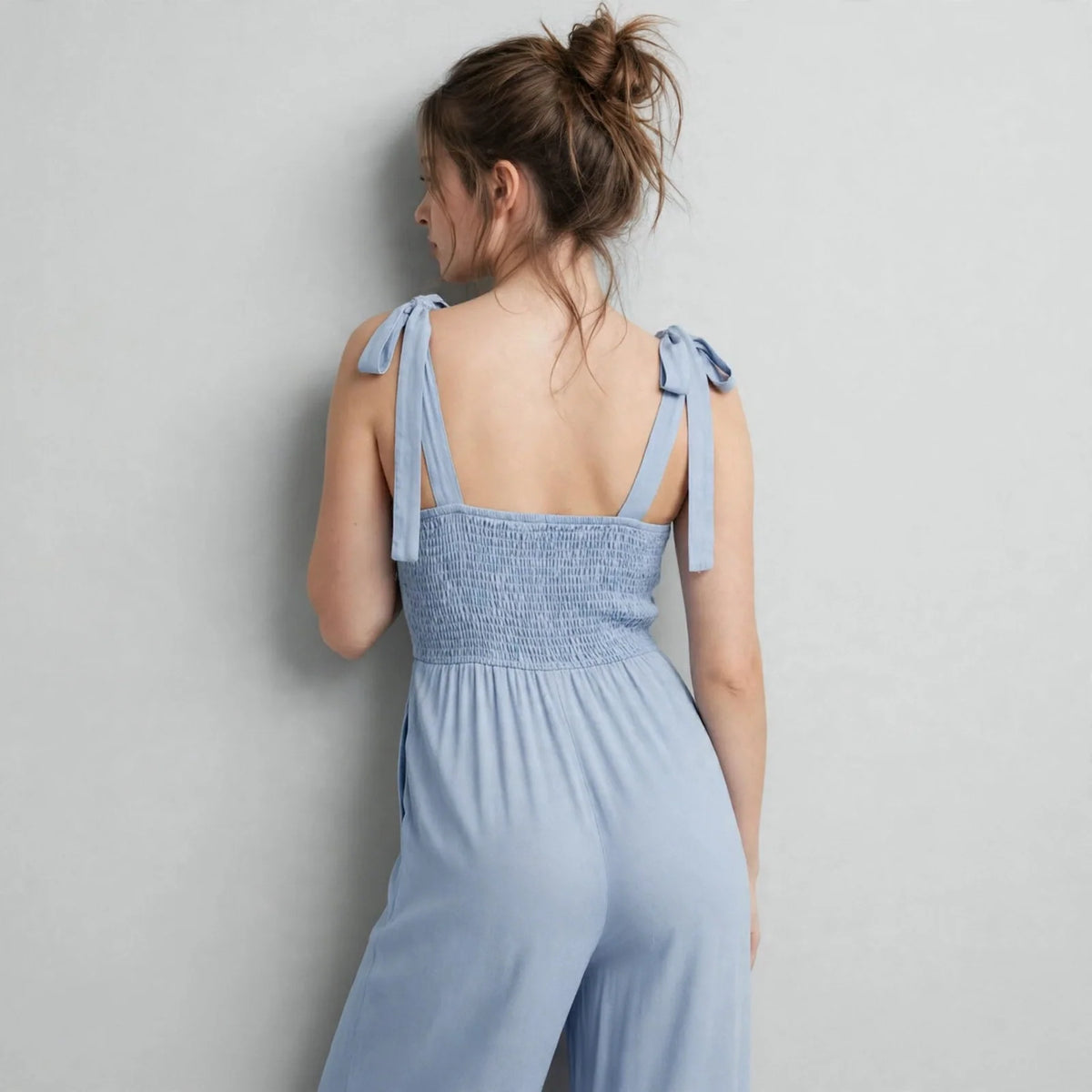 Tie-shoulder wide-leg jumpsuit on model, studio shot
