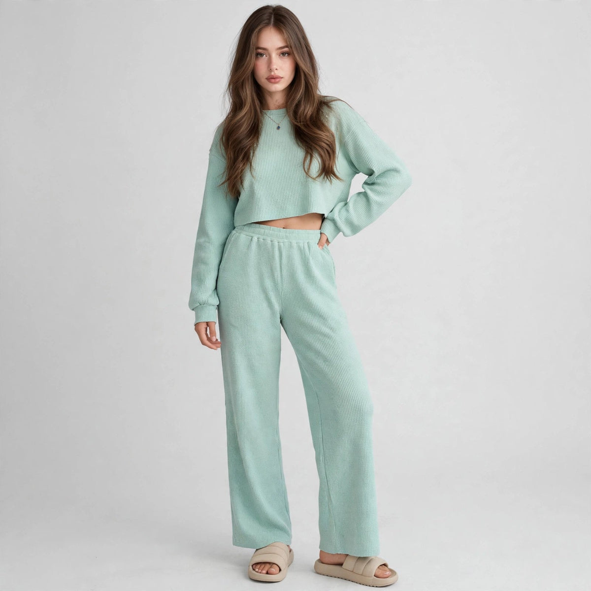 Model in mint waffle-knit cropped top and wide-leg pants set with hand on hip, front studio view, light grey backdrop.