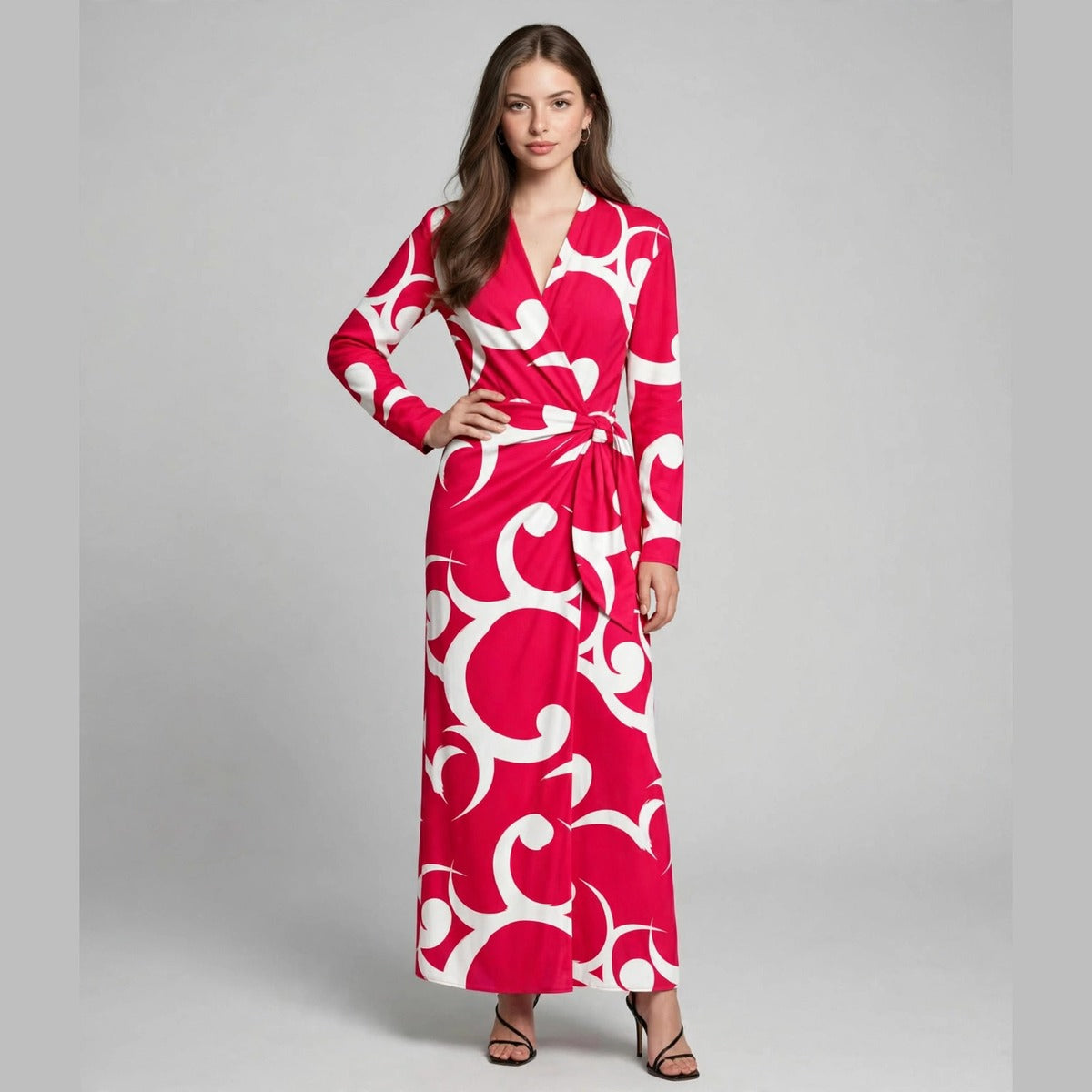Full-length view of a woman in a red shirt dress with bold white abstract swirl print, long sleeves and tie waist.