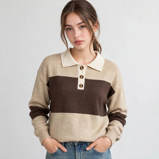 Woman, hands in jean pockets, in beige and brown color-block polo sweater, button placket, front view, light backdrop.