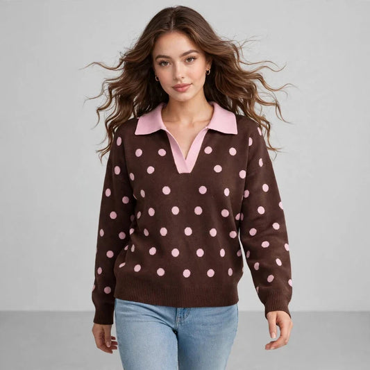 Front view of model wearing a brown polka-dot knit sweater with a pink polo collar and loose fit, paired with blue jeans