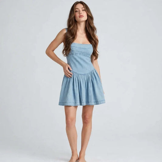 Light Blue Smocked denim mini dress on model, styled studio pose